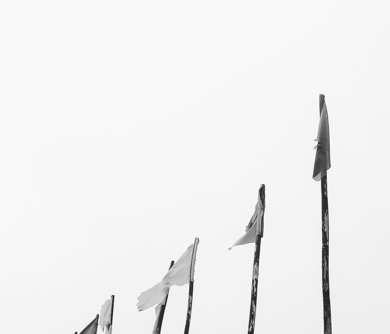 LOW ANGLE VIEW OF FLAGS AGAINST SKY