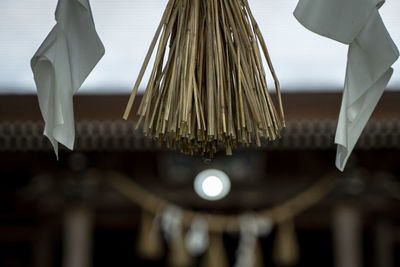 Low angle view of lighting equipment hanging on ceiling