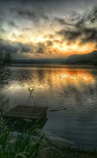 Scenic view of lake against sky at sunset