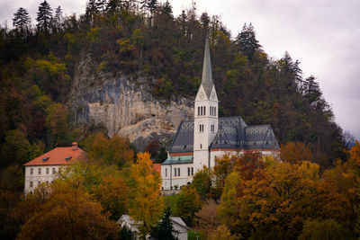 View of temple amidst trees and buildings