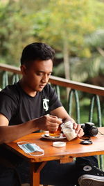 Man having food while sitting at restaurant