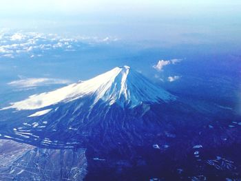 Aerial view of landscape against cloudy sky