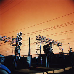 Low angle view of power lines against sky