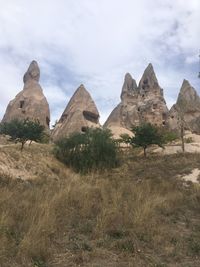 Rock formations on landscape against sky