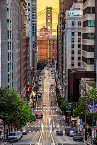 Traffic on road amidst buildings in city