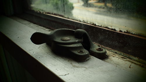 Close-up of metal container on wood