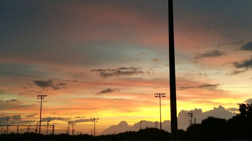 Silhouette of trees against dramatic sky