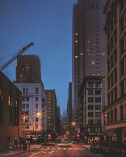 Illuminated city street at night