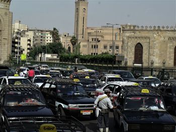 Cars on city against sky