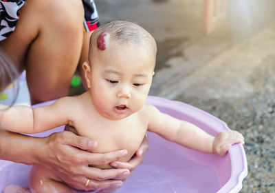 Midsection of shirtless baby girl