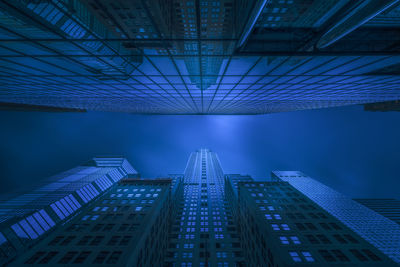 Low angle view of illuminated buildings in city at night