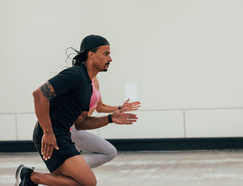 Side view of man exercising in gym