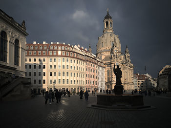 Statue of historic building in city against sky