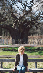 Rear view of woman standing by tree