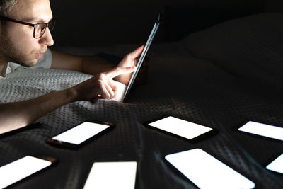 Man using digital tablet on bed at home