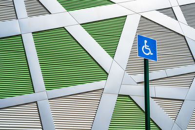 Disabilty parking street sign on a geometrical wall