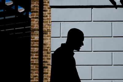 Silhouette of man against wall