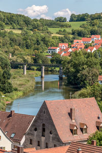 High angle view of buildings by town against sky