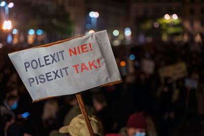 Information sign on street in city at night