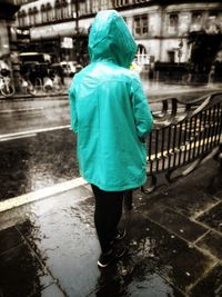 Rear view of woman standing in water