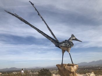 View of sculpture on landscape against sky
