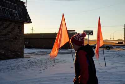 Rear view of man standing in snow