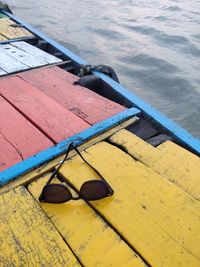 High angle view of sun glasse on colored boat