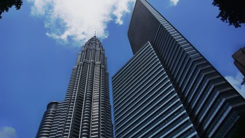 Low angle view of modern building against blue sky