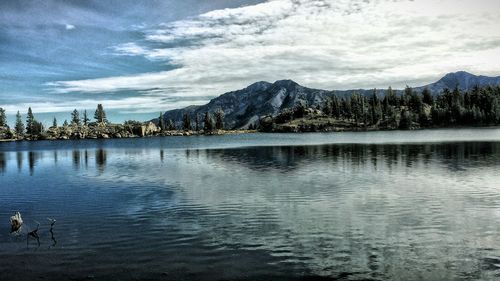 Scenic view of lake against cloudy sky