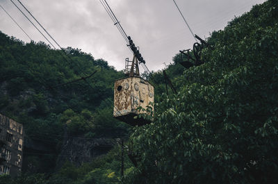 Old rusty overhead cable hanging in forest