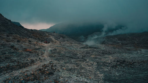 Smoke emitting from volcanic mountain against sky