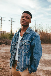 Portrait of young man standing on land