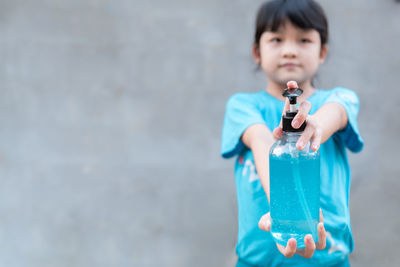 Full length of a boy holding water