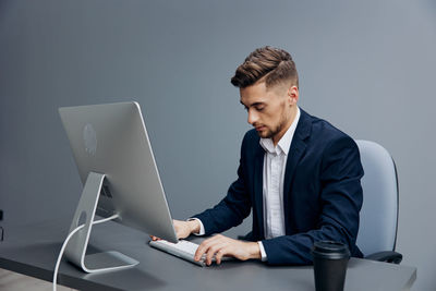 Businessman using desktop pc in office