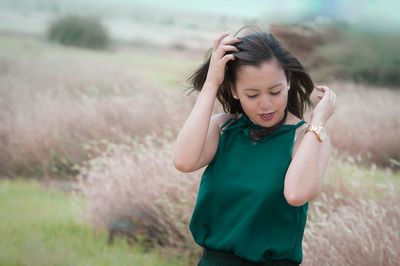 Young woman standing on field