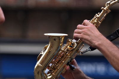 Cropped hands of man playing saxophone