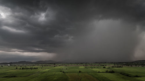 Scenic view of green landscape against sky
