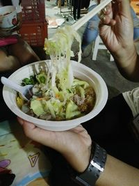 Midsection of person holding food in plate