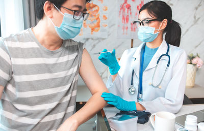 Midsection of man standing with arms raised