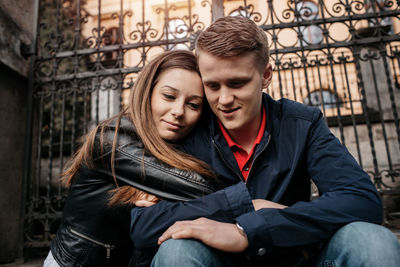 Young couple sitting outdoors