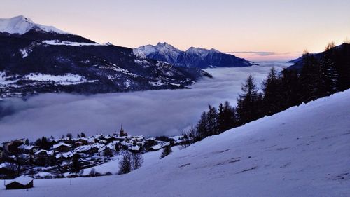 Scenic view of snow covered mountains against clear sky