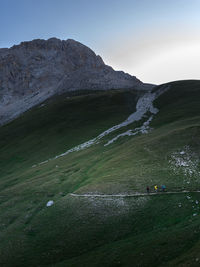 Scenic view of land and mountains against sky