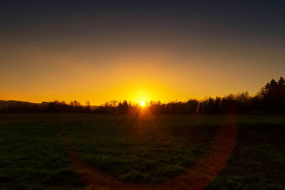 Scenic view of field against sky during sunset