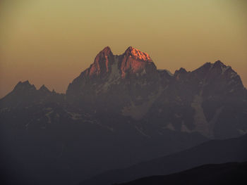 Rock formation against sky during sunset