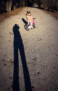 Girl riding bicycle on road