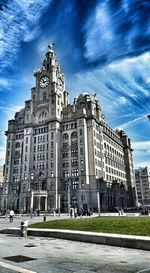 Buildings against cloudy sky