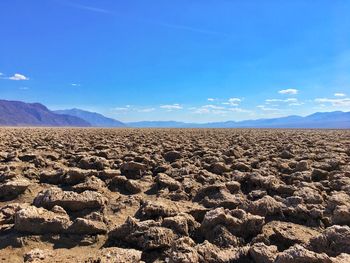 Scenic view of desert against blue sky