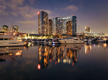 San diego, california, july 5, 2021 -  marriott marquis hotel and yachts reflect in water
