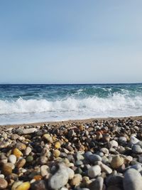 Pebbles on beach against sky