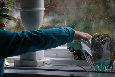 Person holding glass of water